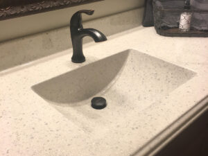 SFI cultured marble bathroom vanity sink top in a light cream color with speckles and a Wave sink bowl.