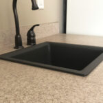 SFI cultured marble bathroom vanity sink top in a light cream color with speckles.