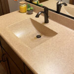 SFI cultured marble bathroom vanity sink top in a light brown speckled color.