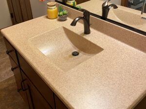 SFI cultured marble bathroom vanity sink top in a light brown speckled color.