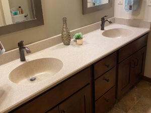 SFI cultured marble bathroom vanity sink top in a cream and light brown speckled color with two sinks.