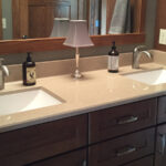 SFI two-toned, cultured marble bathroom vanity sink top with a white sink, speckled tan vanity top, and a gloss finish.