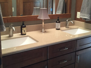 SFI two-toned, cultured marble bathroom vanity sink top with a white sink, speckled tan vanity top, and a gloss finish.