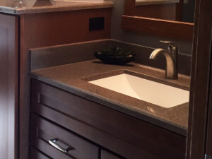 SFI two-toned, cultured marble bathroom vanity sink top with a white sink bowl and dark brown speckled vanity top.
