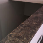 SFI custom cultured marble half-wall shelf.